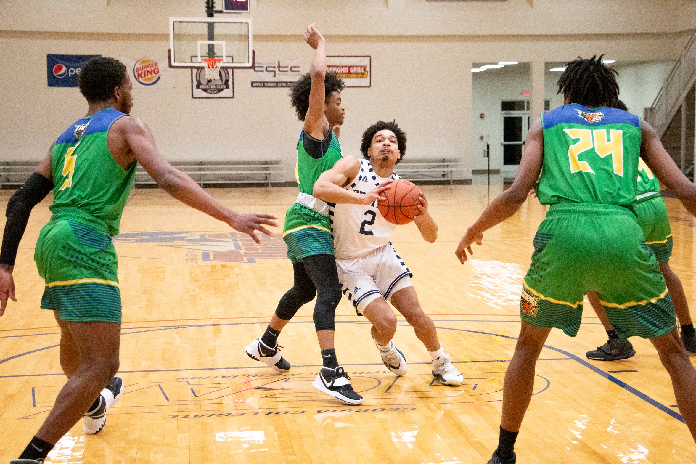 Truitt Spencer taking contact from defender on a drive to the basket